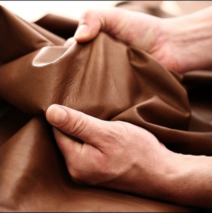 Rossini leather held in the hands of a craftsman